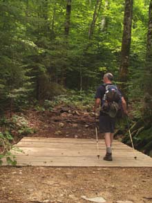 Mark crossing the bridge over East Pond Brook on East Pond Trail (photo by Webmaster)