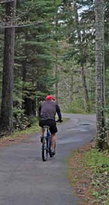 Cyclist along the Franconia Notch bike path (photo by Ben Kimball)