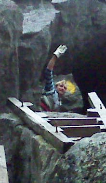 Diana waving from the top of the ladders on Mt. Morgan (photo by Diane King)